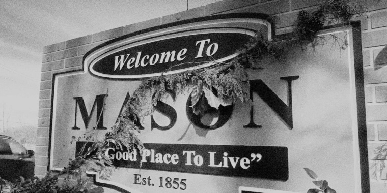 Photo Illustration: A sign welcomes visitors to Mason, Tenn.