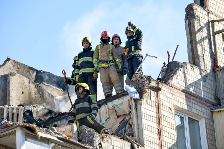 Rescuers remove debris from a residential building damaged by shelling in Kharkiv, Ukraine, on March 16, 2022.