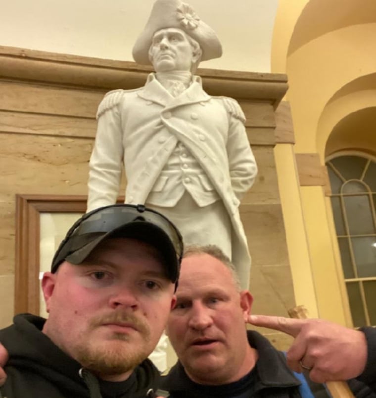 Jacob Fracker, left, and Thomas Robertson at the Capitol Building on January 6, 2021, in front of the monument to John Stark.