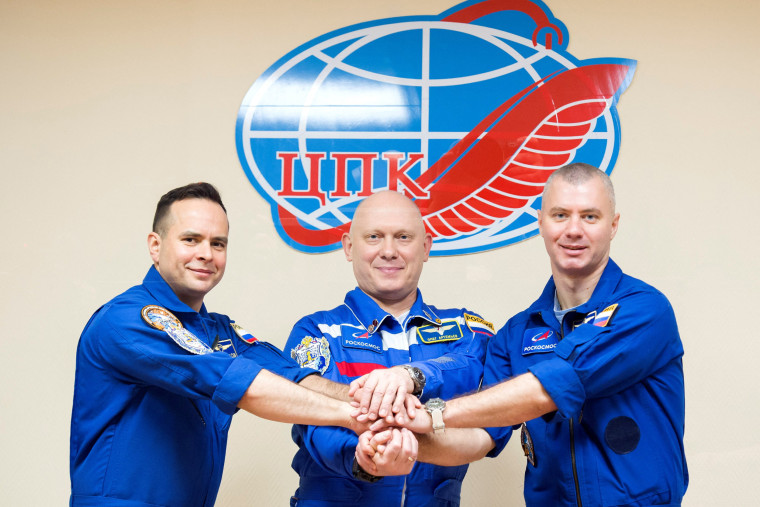 Image: Crew members attend a news conference ahead of the expedition to the International Space Station at the Baikonur Cosmodrome
