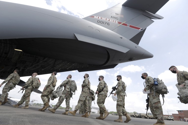 Tennessee National Guard troops board a plane in Smyrna, Tenn., on June 4, 2020. Three current and former members were falsely identified in a Russian media report as mercenaries killed in Ukraine, the Tennessee Guard said.