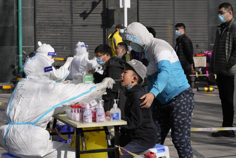 Residents get tested for the coronavirus at an outdoor facility on Monday in Beijing.