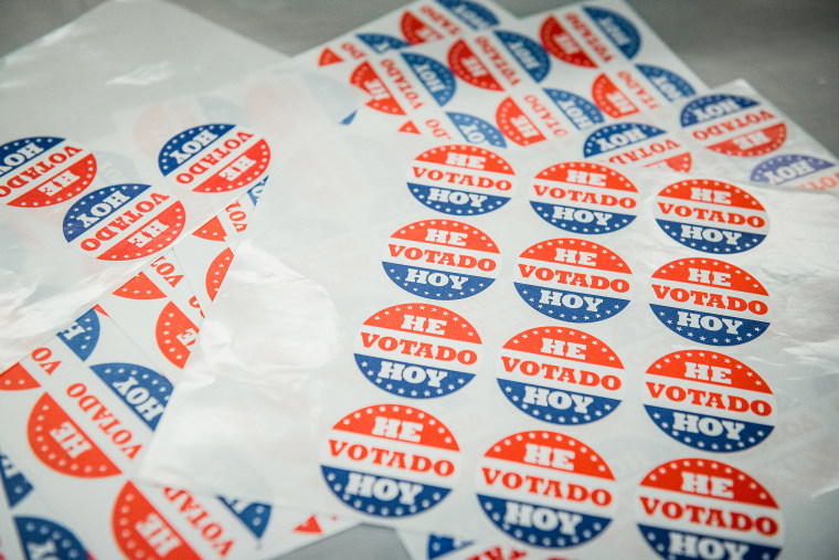 Sheets of stickers reading "I Voted Today" in Spanish are displayed on a table at a polling station in Philadelphia on June 2, 2020.