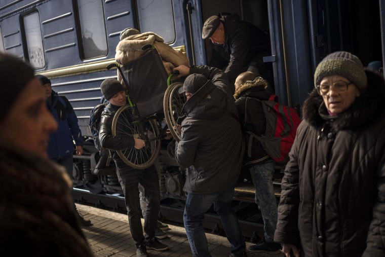 Ukrainians escaping from the besieged city of Mariupol along with other passengers from Zaporizhzhia arrive at Lviv, western Ukraine, on Sunday, March 20.
