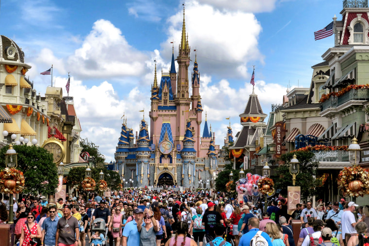 Guests walk past Cinderella Castle in the Magic Kingdom at Walt Disney World on October 1, 2021 in Lake Buena Vista, Fla.