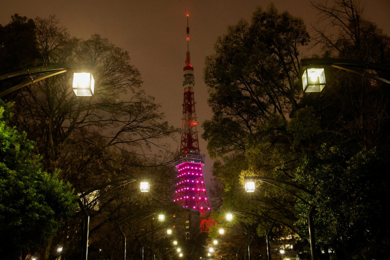 Image: Tokyo Tower is illuminated only in the lower-half part in response to the government's request to save electricity in Tokyo