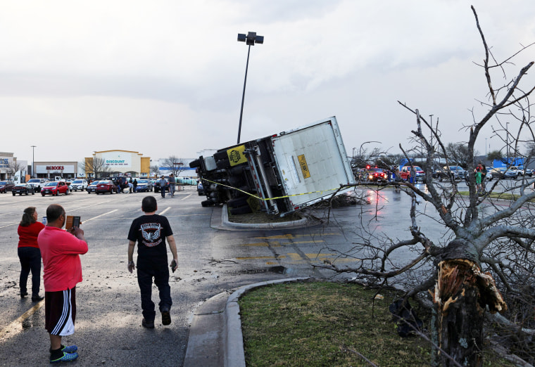 An overturned truck in a parking lot
