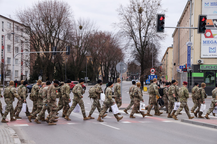 Soldiers from the U.S. Army's 82nd Airborne Division depart after many of them participated in a commemorative run with locals in the town center on March 6, 2022, near Mielec, Poland.