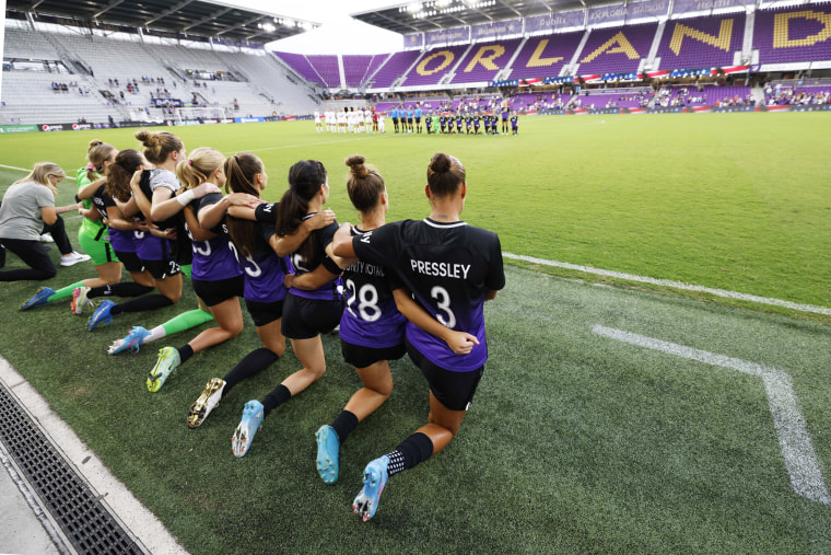 Orlando Pride players kneel during the national anthem