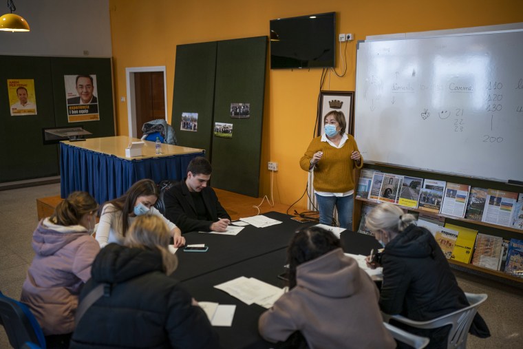 Carme, a resident from Catalonia, teaches Catalan language to Ukrainian refugees in the village of Guissona in Lleida, Spain, on March 22, 2022.