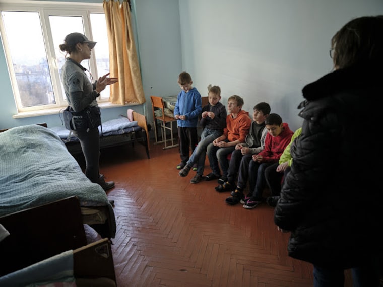 Pediatric nurse practitioner Janet Semenova-Hornstein is shown here with Ukrainian orphans in Lviv. Semenova-Hornstein assessed and treated the orphans for conditions including pneumonia and upper respiratory infections, after the children spent up to two weeks in bomb shelters.