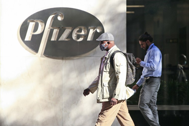 People walk by the Pfizer world headquarters