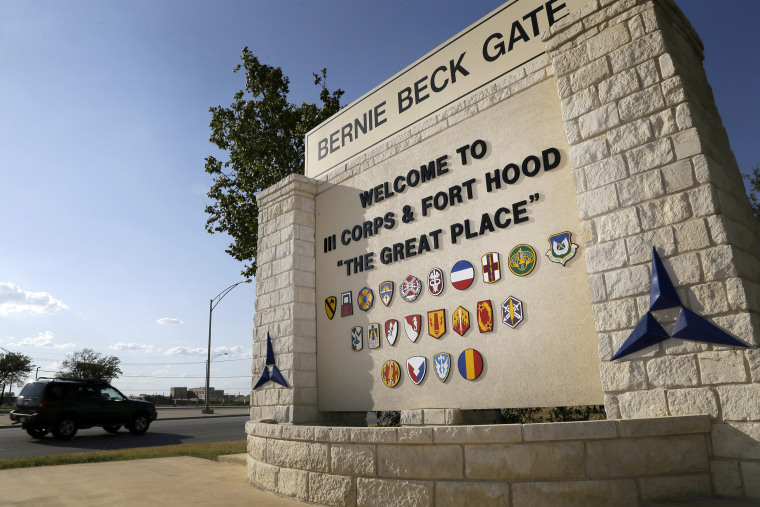 Traffic flows through the main gate past a welcome sign in Fort Hood, Texas, on July 9, 2013.