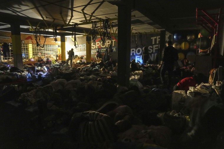 People prepare for the night in the improvised bomb shelter in a sports center, which can accommodate up to 2000 people, in Mariupol, Ukraine on Feb. 27, 2022. 