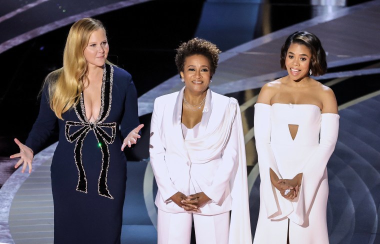Co-hosts Amy Schumer, Wanda Sykes, and Regina Hall speak onstage during the Academy Awards in Los Angeles on Sunday.
