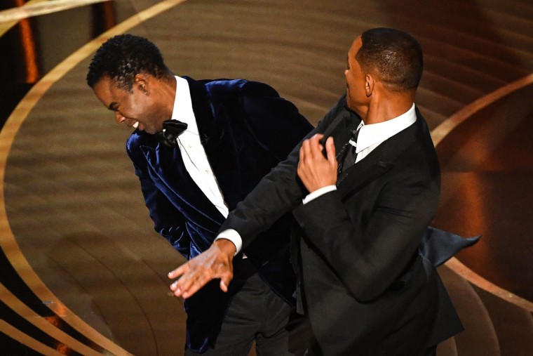 Image: Will Smith, right, hits presenter Chris Rock on stage while presenting the award for best documentary feature at the Oscars on Sunday in Los Angeles.