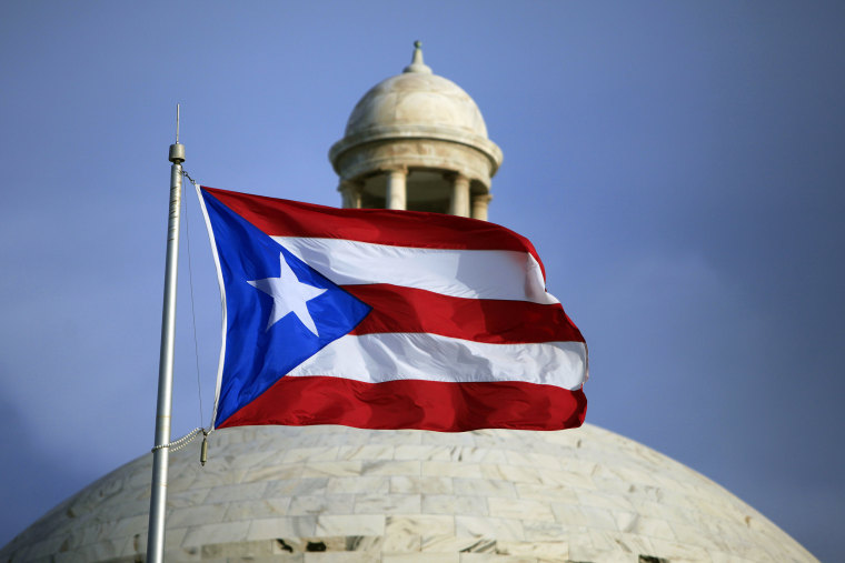 The Puerto Rican flag flies in front of the Puerto Rico Capitol in San Juan.