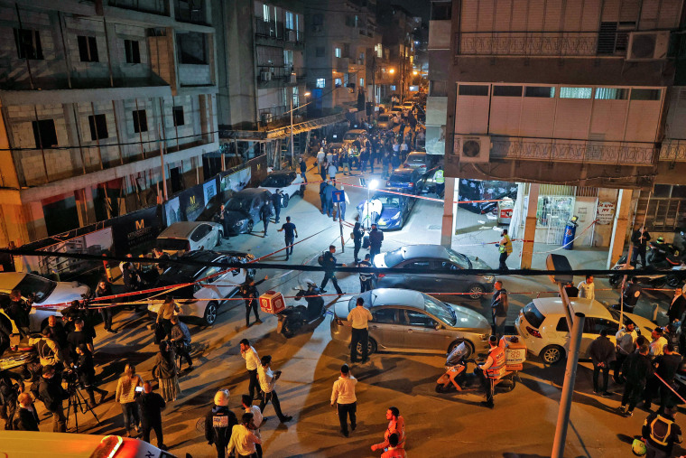 Image: Israeli security forces and emergency personnel gather at the scene of a shooting attack on March 29, 2022 in Bnei Brak.