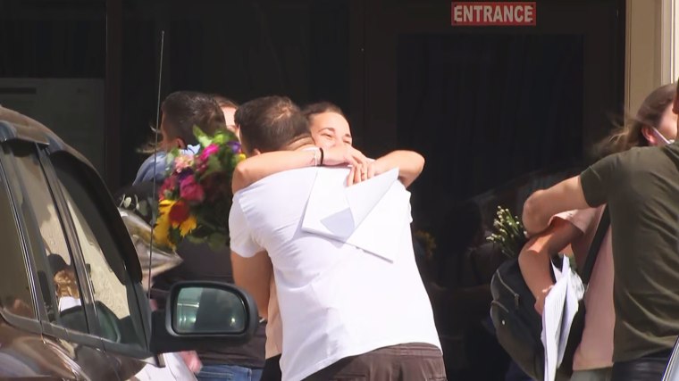 Maksym Armash and Olena Poloziuk hug