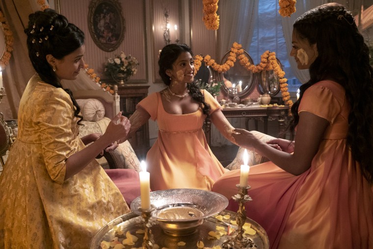 A haldi ceremony in "Bridgerton." Pictured: Shelley Conn as Mary Sharma, Charithra Chandran as Edwina Sharma, Simone Ashley as Kate Sharma in episode 206 of Bridgerton. 