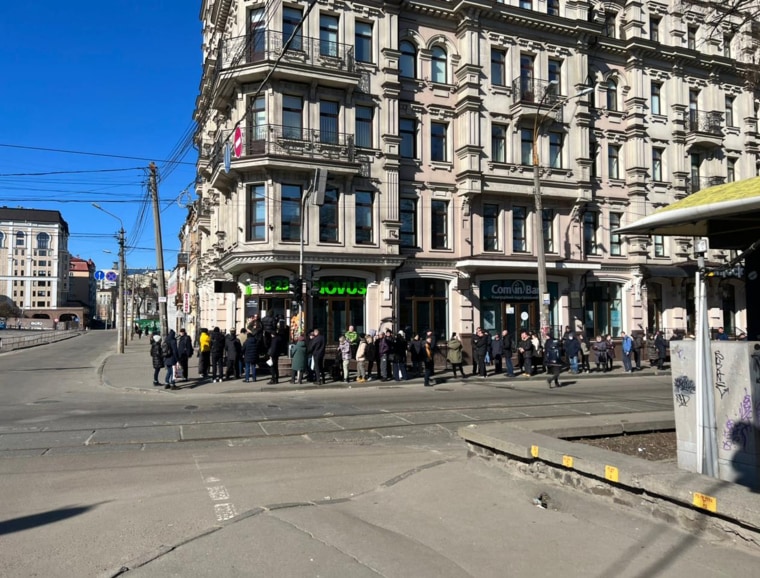 A long line of people in Kyiv, trying to obtain food, water, and other supplies before the mandated curfew. 