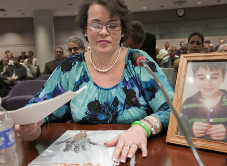 Veronique De La Rosa with a photo of her son Noah, testifying on gun laws in Hartford, Conn. Leonard Pozner and De La Rosa, the parents of Noah Pozner, one of the 20 children killed in the Sandy Hook shooting, are part of the defamation lawsuit against Alex Jones. 