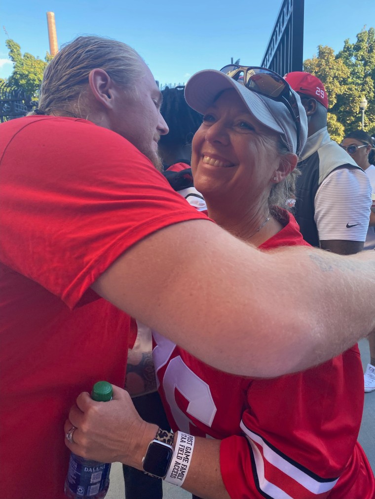 The former football player hugs his mother, who says she is proud of her son for opening up about his mental health struggles. 