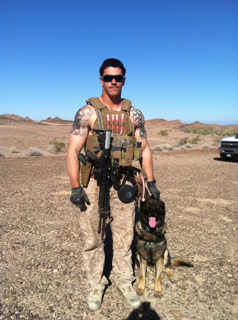Sgt. Joshua Ashley, pictured with his working military dog, Sirius, in combat.
