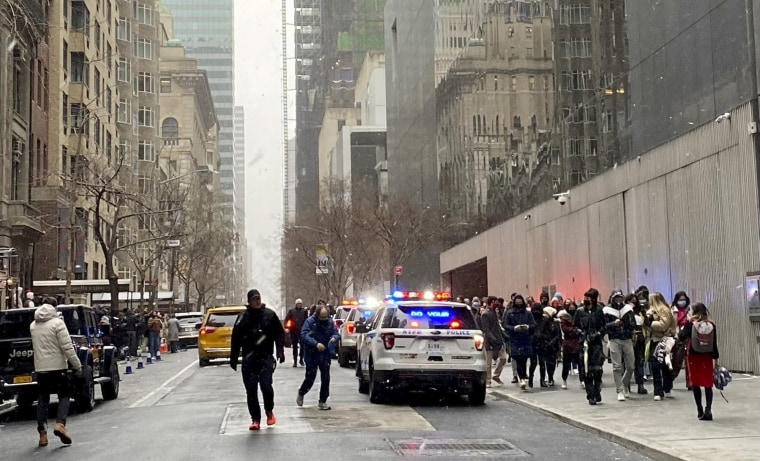 In this photo from a social media post by Scott Cowdrey, people are evacuated from the Museum of Modern Art where a stabbing occurred, Saturday, March 12, 2022, in New York. Police said two people were stabbed inside MoMA and in stable condition at Bellevue Hospital.