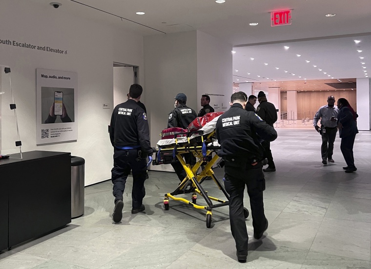 In this photo provided by Yuichi Shimada, medical personnel respond at the Museum of Modern Art in New York after a man stabbed two employees after he was denied entrance for previous incidents of disorderly conduct, Saturday, March 12, 2022.