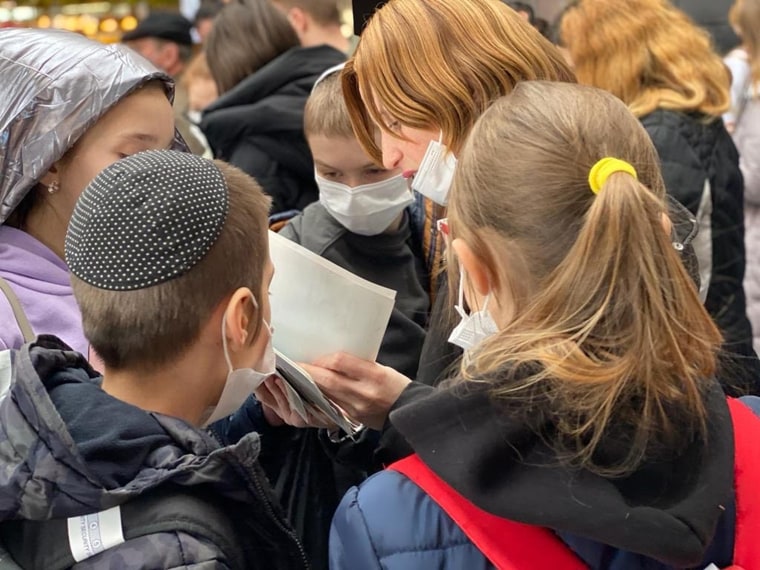 Volunteers and humanitarian workers preparing orphan Ukrainian children to flee from Ukraine as Russian forces began their invasion.