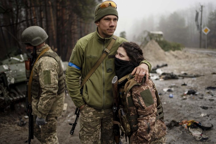 Ukrainian army soldier Igor, 23, embraces his wife Dasha, 22, after a military sweep to search for possible remnants of Russian troops after their withdrawal from villages in the outskirts of Kyiv on Friday, April 1.