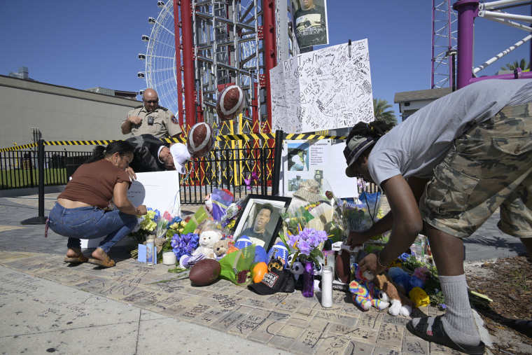 People visit a makeshift memorial for Tyre Sampson outside the Orlando Free Fall ride at the ICON Park entertainment complex, on March 27, 2022, in Orlando, Fla.