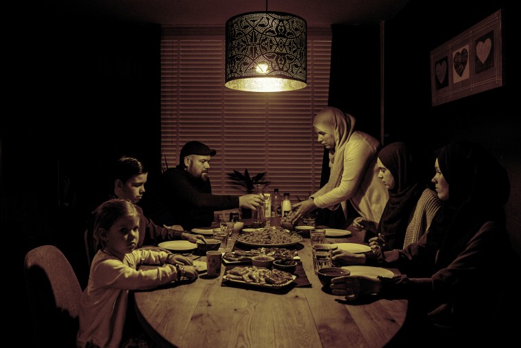 A Muslim family at the table having the iftar meal after