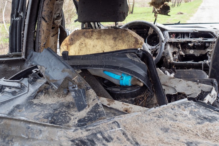 A child's bottle in the back of a destroyed car, left after Russian forces allegedly opened fire on the vehicle in Havronshchyna.
