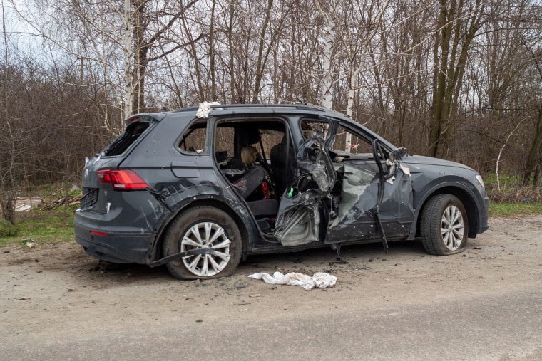A damaged car is left by the roadside in the town of Havronshchyna. 
