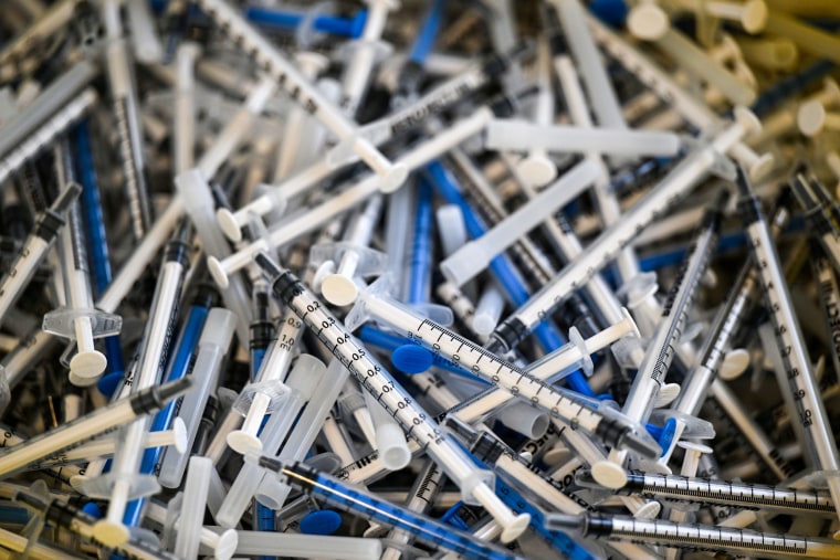 Used syringes for Covid-19 vaccinations lie in a container at the Catholic Hospital vaccination center, in Thuringia, Germany, on Feb. 28, 2022.