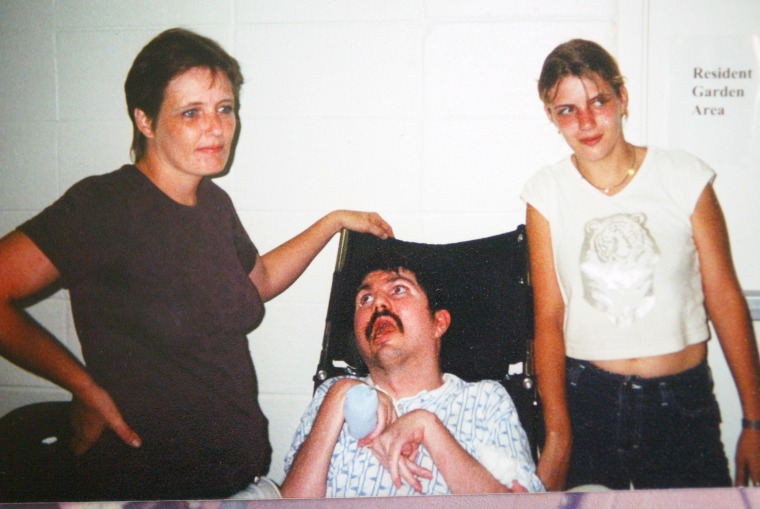 Terry Wallis, center, his wife Sandra, left, and their daughter Amber at a rehabilitation center in Mount View, Ark., in 2002.