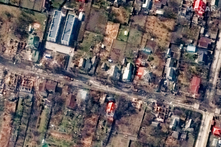 A Maxar satellite image shows destroyed homes and vehicles along Vokzalna Street in Bucha, Ukraine, on March 31, 2022.