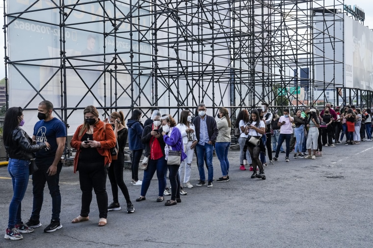 People line up to get into the concert of Mexican singer Alejandro Fernandez and Colombian singer Jessi Uribe in Caracas, Venezuela, on March 3, 2022.