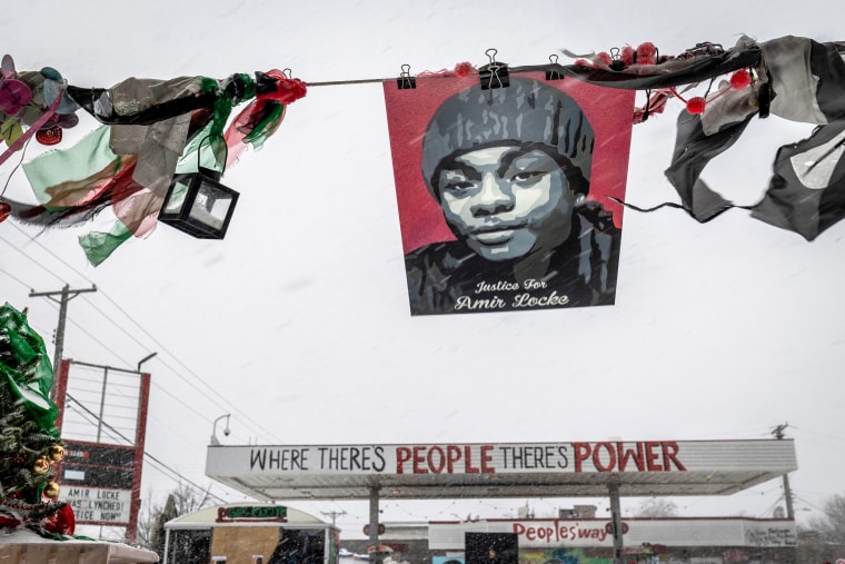 Amir Locke's picture is seen during a heavy snowstorm at George Floyd Square in Minneapolis on Feb. 22, 2022.
