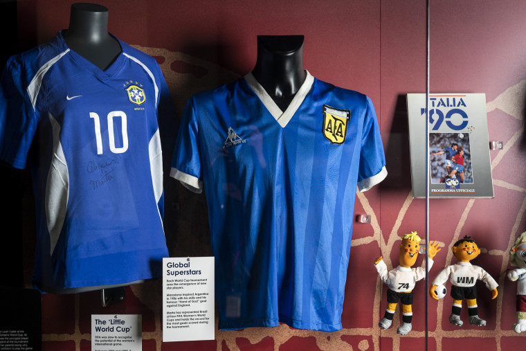 The soccer shirt, center, worn by Argentina's Diego Maradona in the 1986 World Cup quarterfinal against England is displayed at the National Football Museum in Manchester, England, on Nov. 26, 2020.