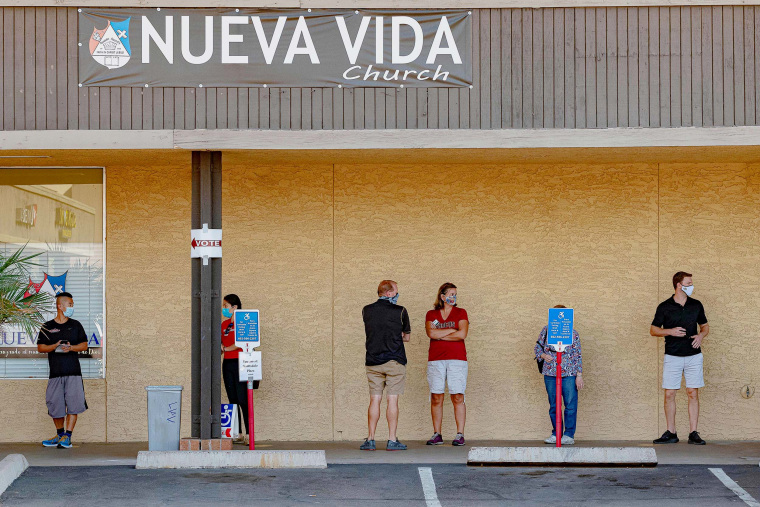 People wait in line to vote at a polling place at the Scottsdale Plaza Shopping Center, in Scottsdale, Ariz. on November 3, 2020.