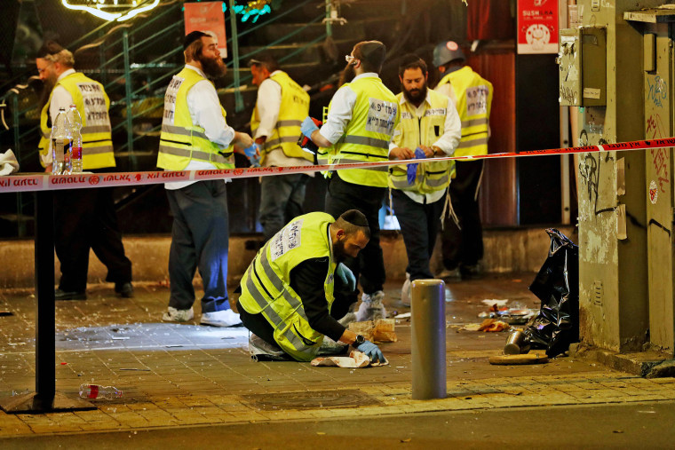 Image: Forensic experts investigate the scene of a shooting incident on Dizengoff Street in Tel Aviv on April 7, 2022.