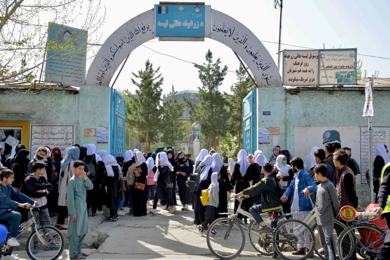Image: Girls leave their school after attending only hours following reopening in Kabul on March 23, 2022.
