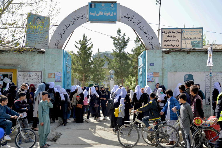 Image: Girls leave school after attending just hours after reopening in Kabul on March 23, 2022.