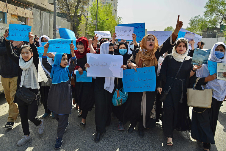 Image: Afghan women and girls take part in a protest in front of the Ministry of Education in Kabul on March 26, 2022, demanding that high schools be reopened for girls.