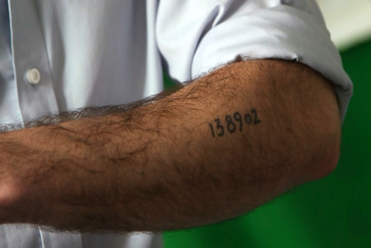 Lang shows his grandfather's Auschwitz ID number tattooed on his arm.