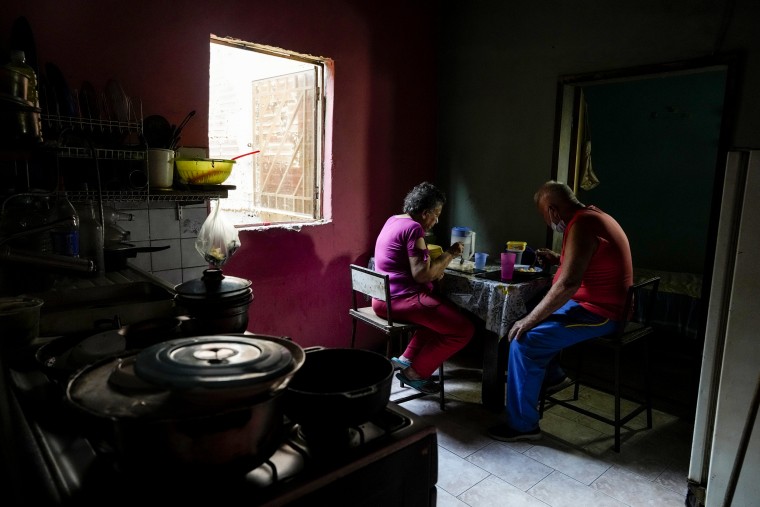 Elderly married couple Maybel Sequera and Juan Gonzalez eat lunch at home in the low-income neighborhood of La Vega in Caracas, Venezuela, on April 7, 2022.