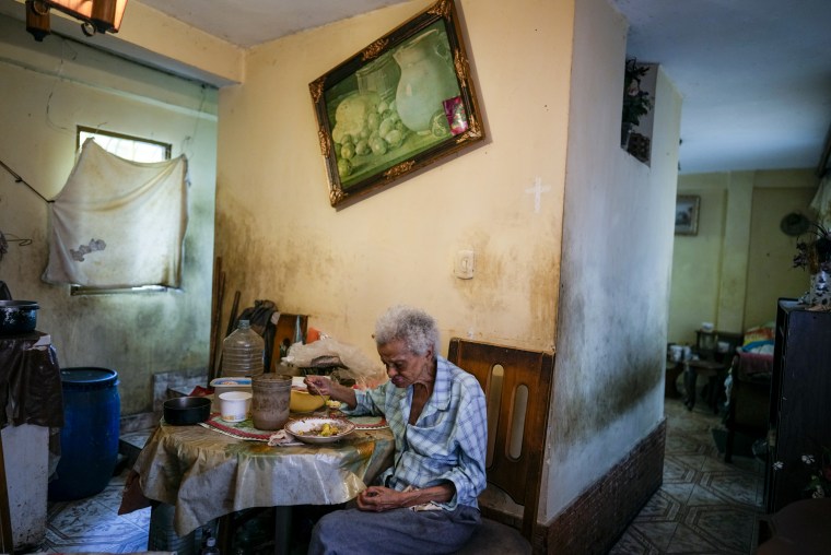 Zenobia Ansualve eats lunch at her home in Caracas, Venezuela, on Aug. 18, 2021.